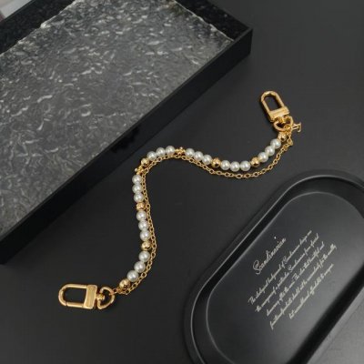 Lv 腰带链以双链设计宣示潮流个性：一条融汇珠饰，并以金属串珠拼写 Vuitton 标识，另一条借链环释放经典韵味。可悬挂于束带圈，为裤装造型点亮瞩目一隅 双链