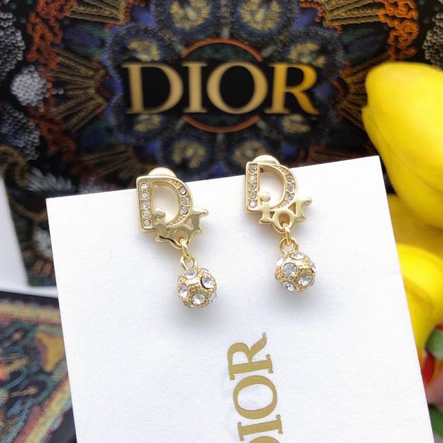 编号Ded0260 Di0R 新款Di0R 字母圆球耳钉 以醒目的金色金属覆层“Di0R”标志，圆形周围闪烁着白色仿水晶。华丽惊艳，时尚百搭，为造型赋予优雅气质