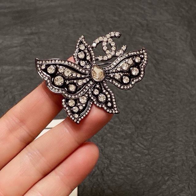 Chanel小香奈儿 专柜新款同步上新黑色蝴蝶带钻香奈儿胸针，是最懂女人的饰物。那些倾注了全部心血去做自己的女人，往往更珍惜胸针的意义。香奈儿女士把胸针别在帽子